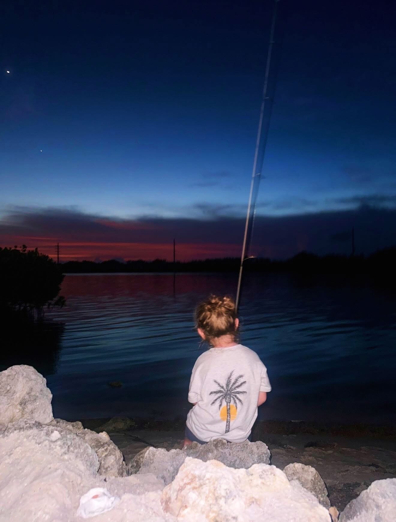Family fishing together at dusk
