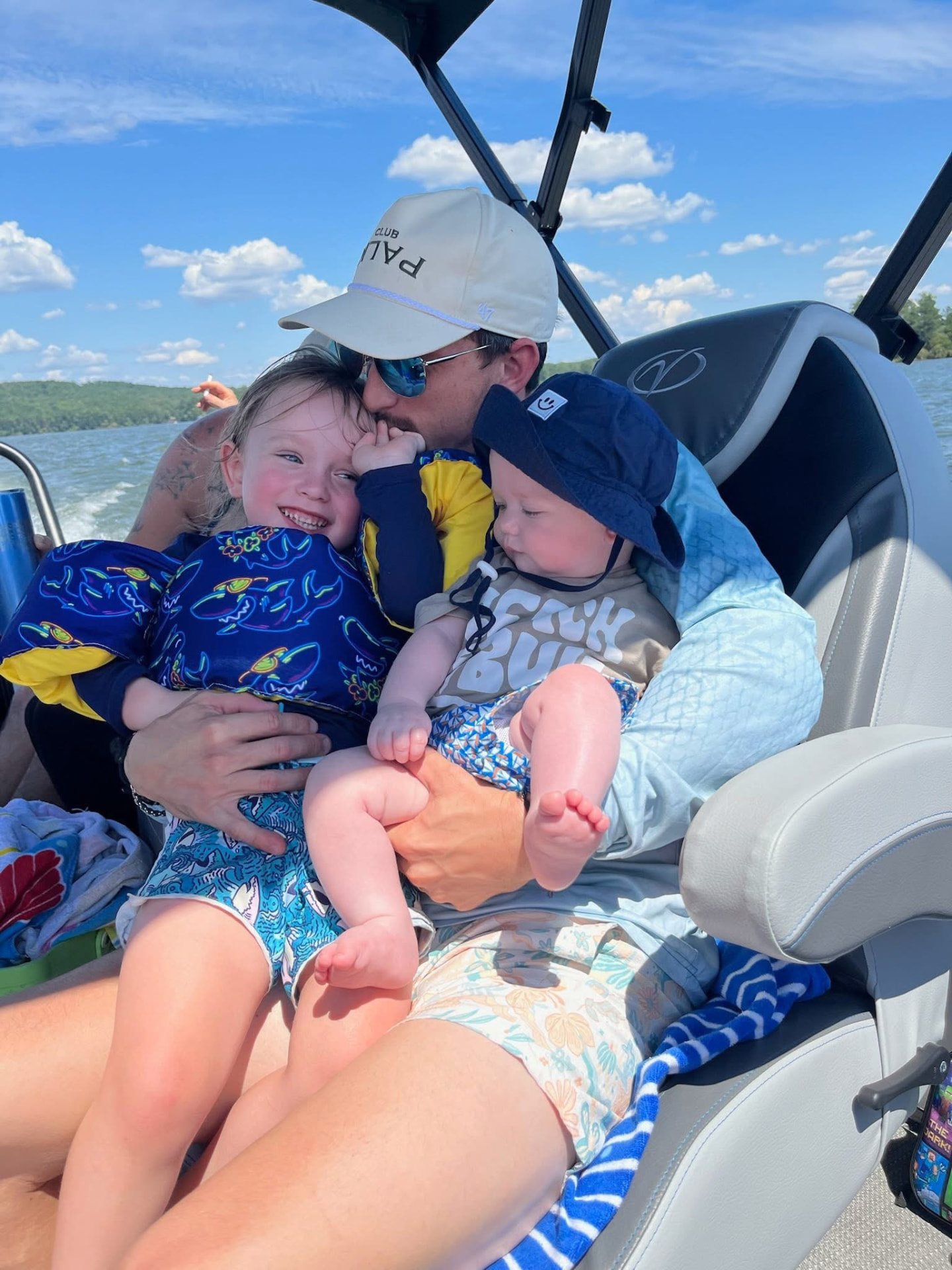 Dad on the boat with the two boys