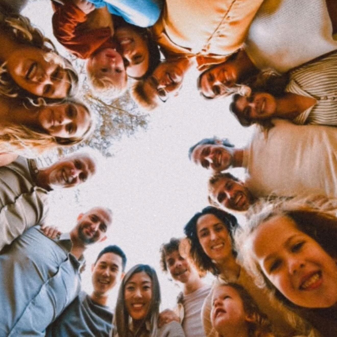 The family in a circle, arms around each other
